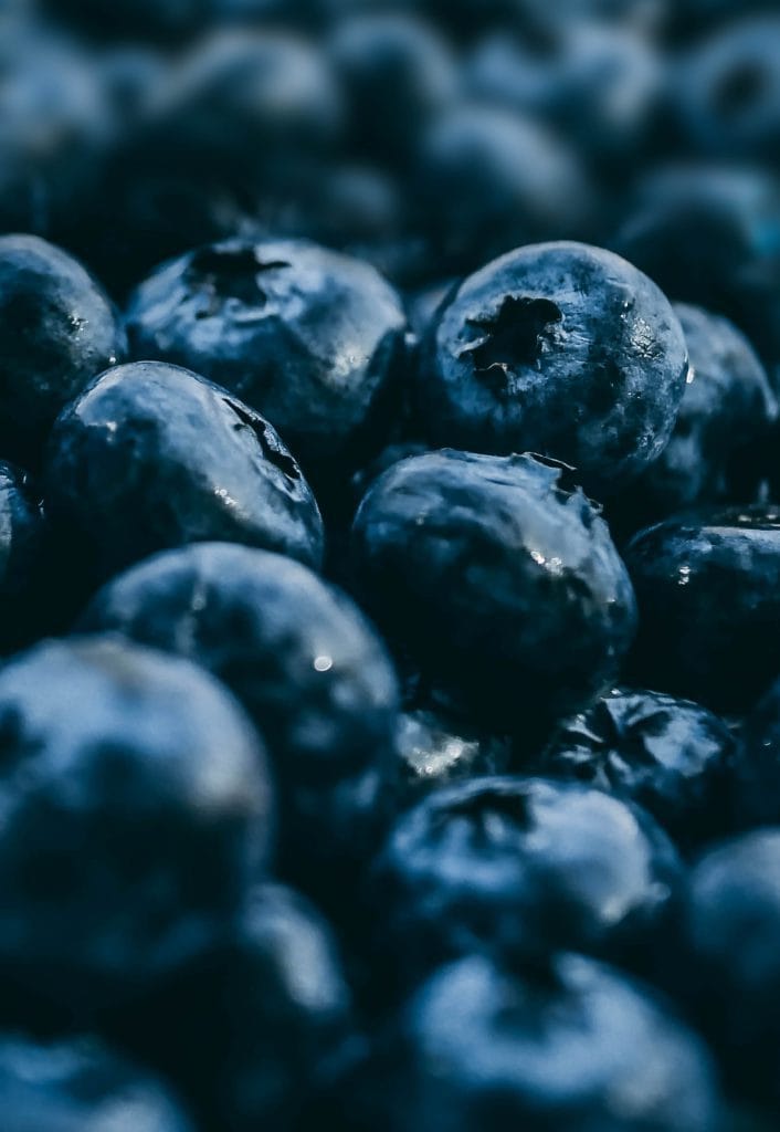 selective focus photography of blueberry